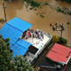 People on rooftops awaiting aid in a flooded area in Kerala in August 2018.